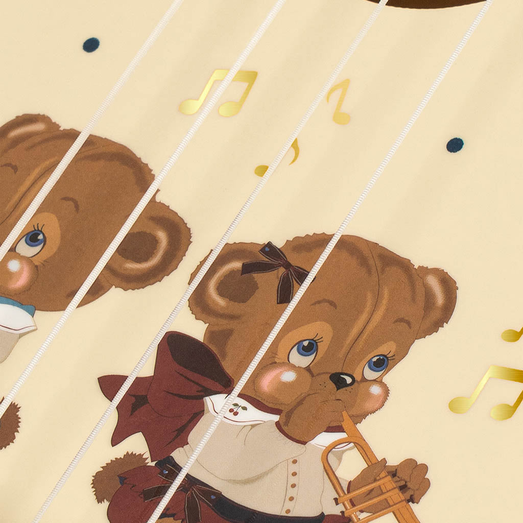 Glänzende Ukulele mit Teddybär